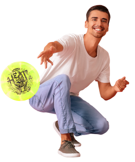 A man holding a yellow frisbee in a park.